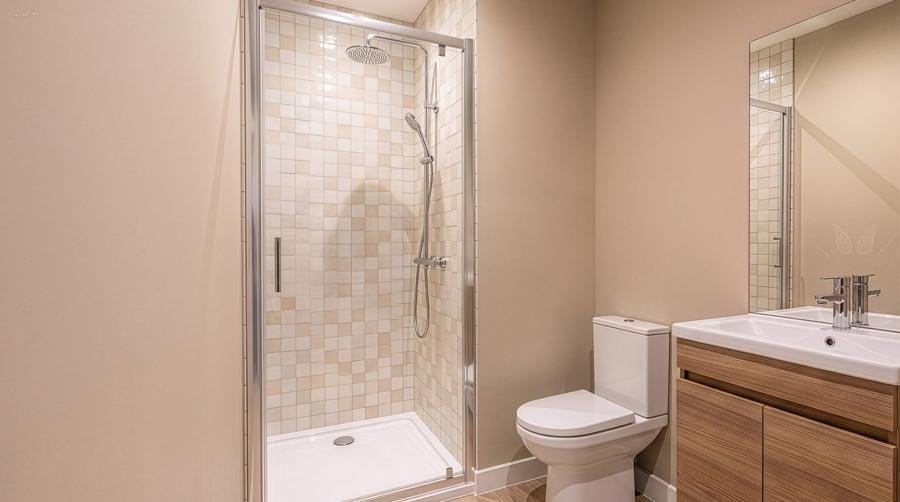 Salle d'eau avec douche à paroi vitrée et meuble vasque